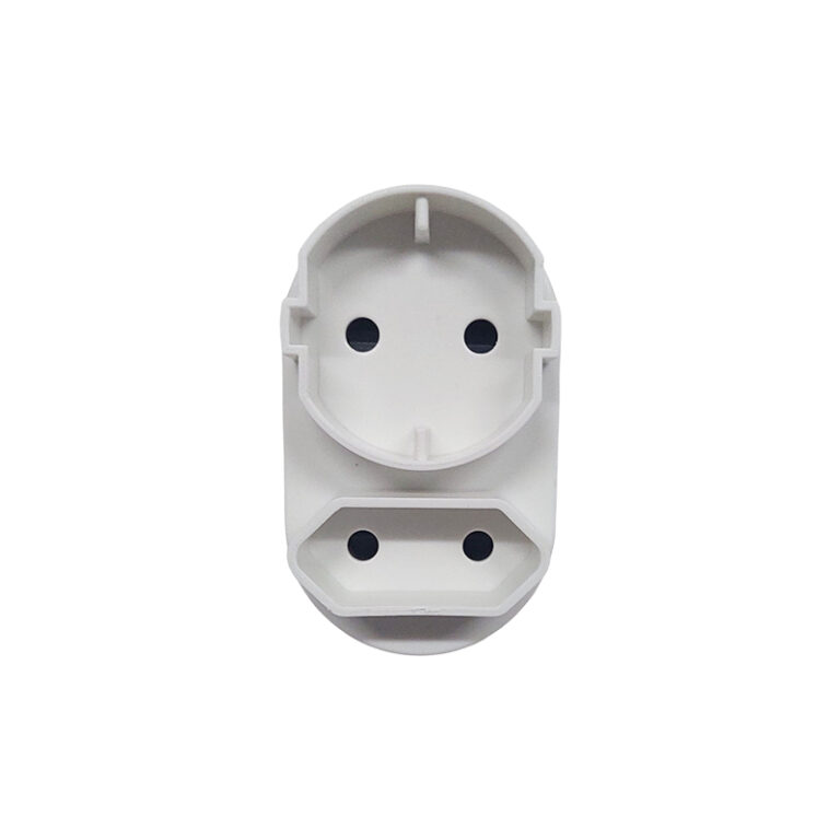 White plastic electrical outlet adapter with two circular socket holes on the top and two on the bottom against a white background; a modular power plug component.