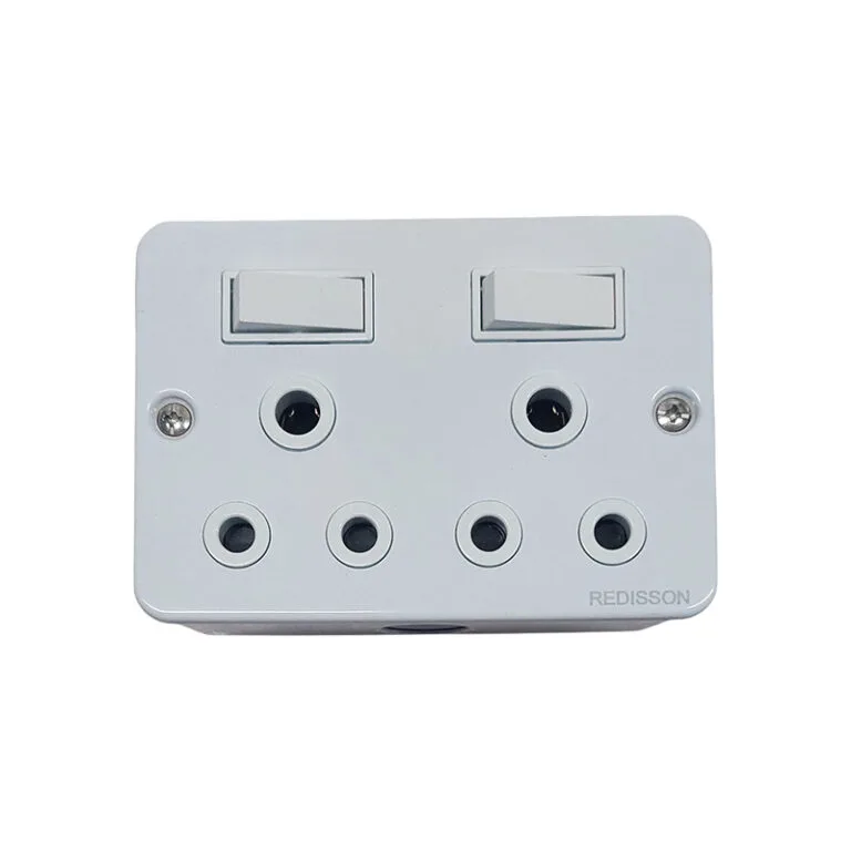 White wall-mounted multi-socket power adapter with two rocker switches and six circular outlets, brand Redis… on the corner