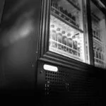 5 | Securadeal Black and white Photo of a Glass door Refrigerator with Bottled Drinks on the Shelves