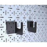w | Securadeal Two Black Metal Wall Brackets Mounted on a Perforated Steel Panel Ready to Support a Shelf or Rod