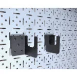 w | Securadeal Two Black Metal Wall Brackets Mounted on a Perforated Steel Panel Ready to Support a Shelf or Rod