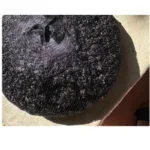 1 | Securadeal Large Round Black Mesh Bag Filled with Dark Shiny Material Resting on a Light Concrete Surface a Foot in a Sandal is Visible Nearby