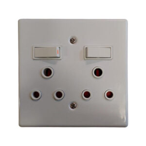 White dual-switch wall plate with several round UK-style outlets arranged in two rows beneath the switches