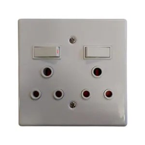 White dual-switch wall plate with several round UK-style outlets arranged in two rows beneath the switches
