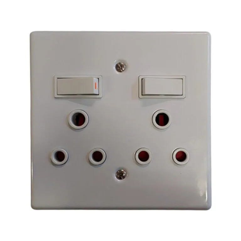 White dual-switch wall plate with several round UK-style outlets arranged in two rows beneath the switches