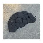 A10992 - 2 | Securadeal Cluster of Black Circular Stones Arranged on a Gray Asphalt Surface