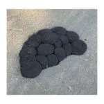 A10992 - 2 | Securadeal Cluster of Black Circular Stones Arranged on a Gray Asphalt Surface